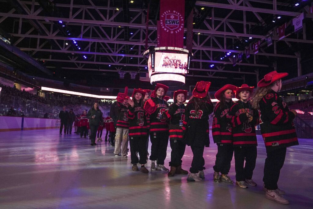 A group of athletes skating on the rink