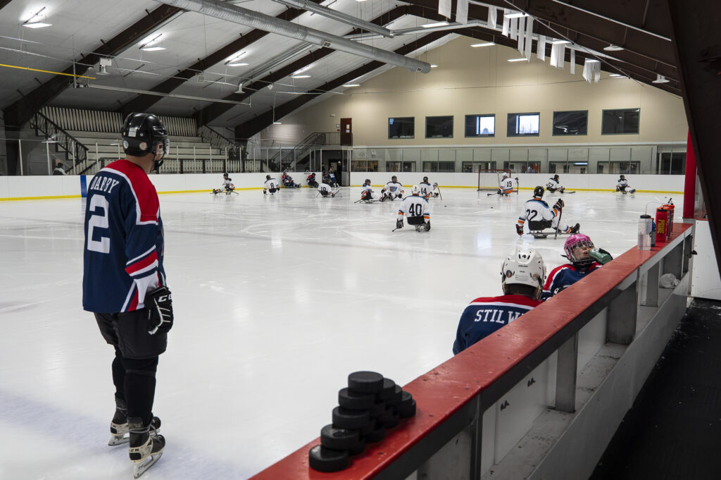A group of athletes skating with helmet on the rink