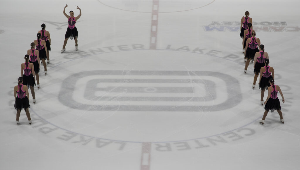 A group of athletes skating on the rink