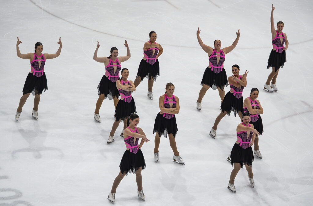 A group of athletes skating on the rink
