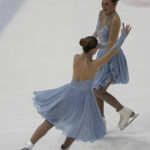 Two athletes skating on the rink