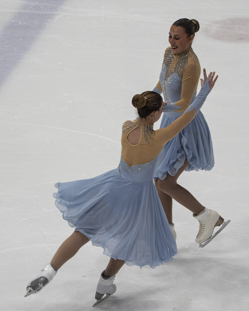 Two athletes skating on the rink
