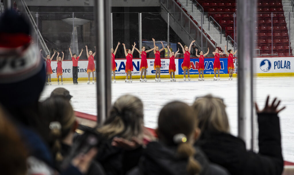 A group of athletes skating on the rink