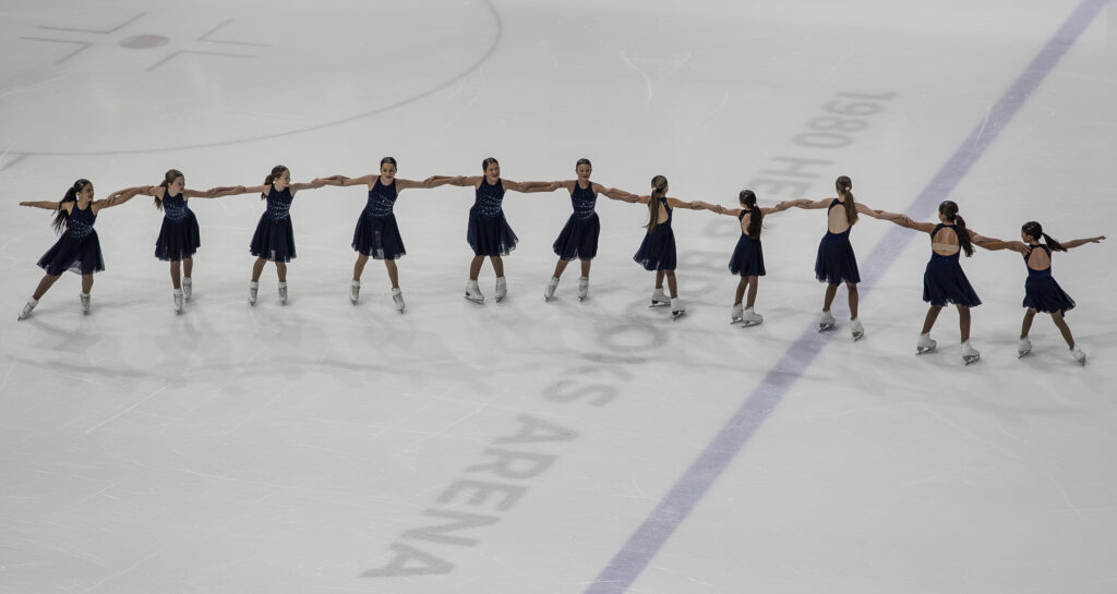 A group of athletes skating on the rink
