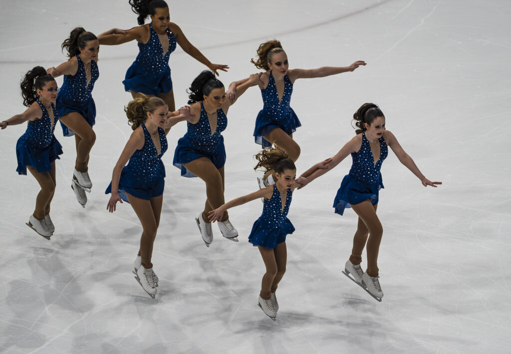 A group of athletes skating on the rink