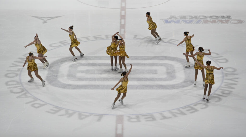 A group of athletes skating on the rink