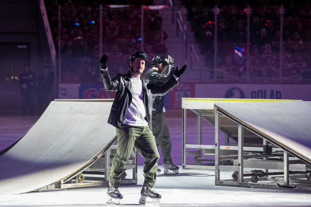 A group of athletes skating with helmet on the rink