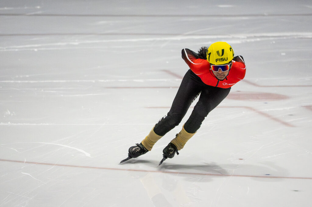 An athlete skating with helmet on the rink