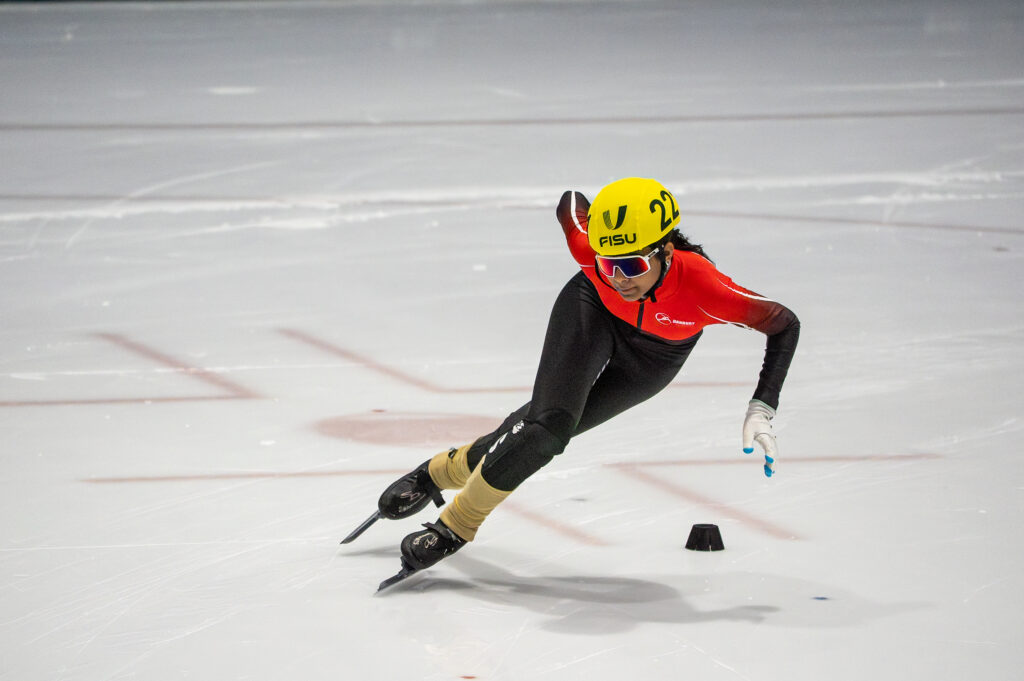 An athlete skating with helmet on the rink