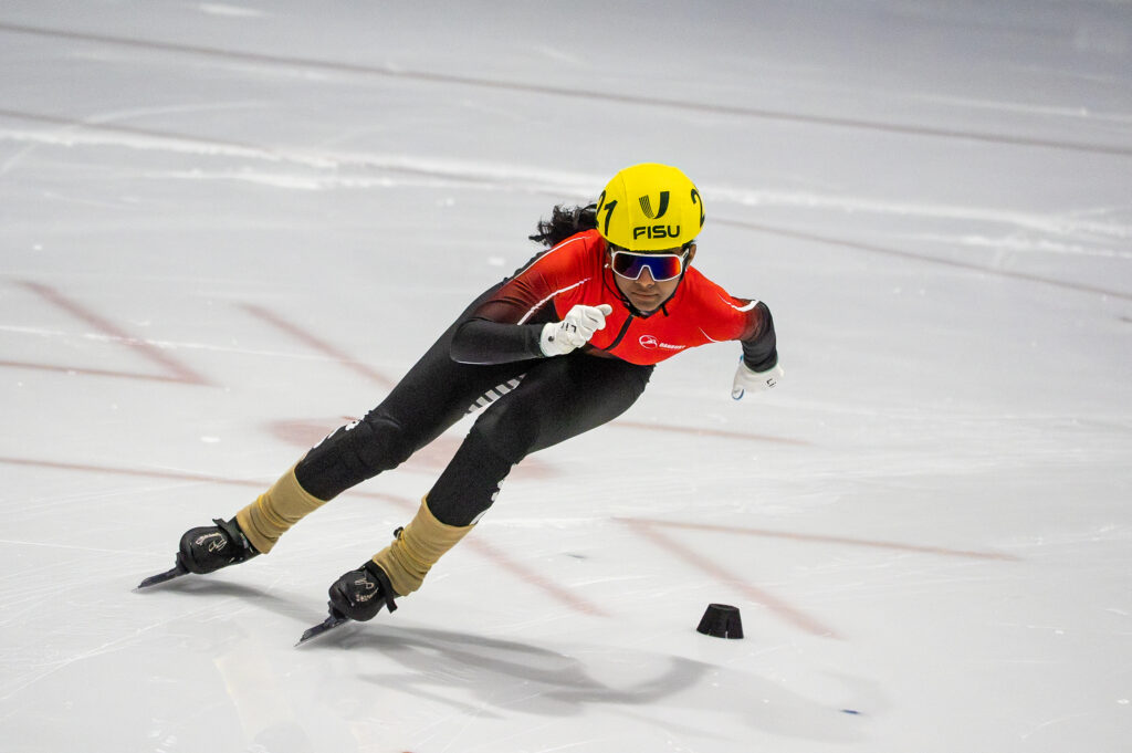 An athlete skating with helmet on the rink