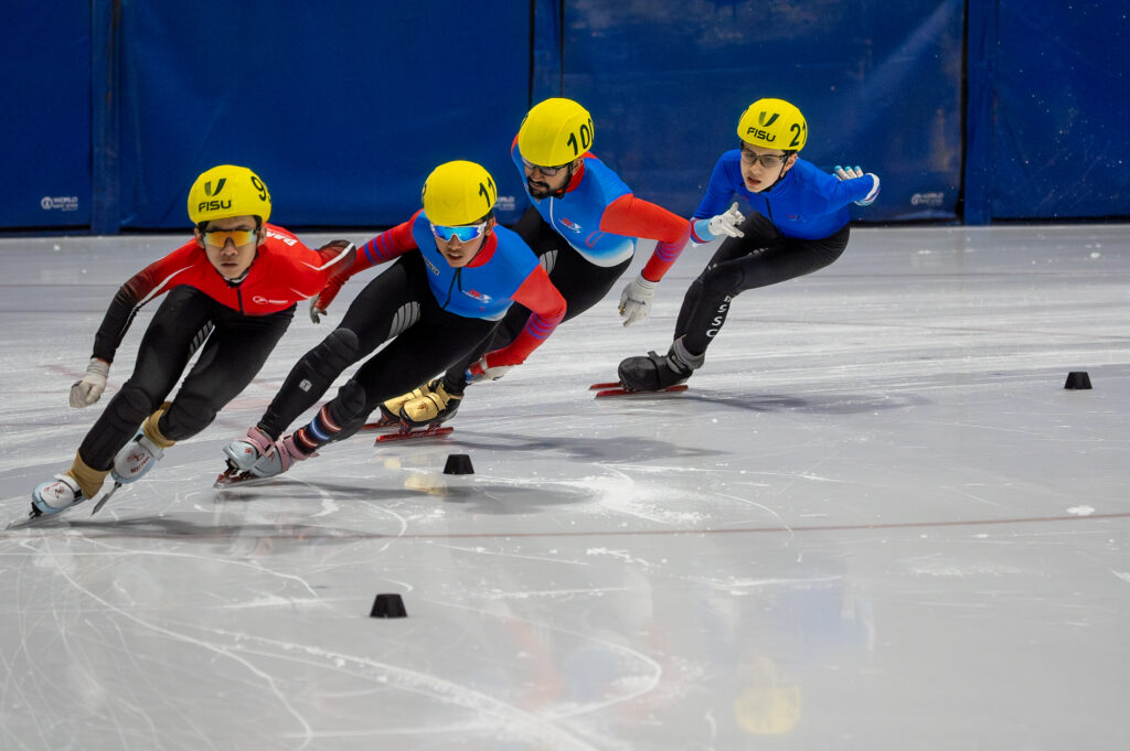 A group of athletes skating with helmet on the rink
