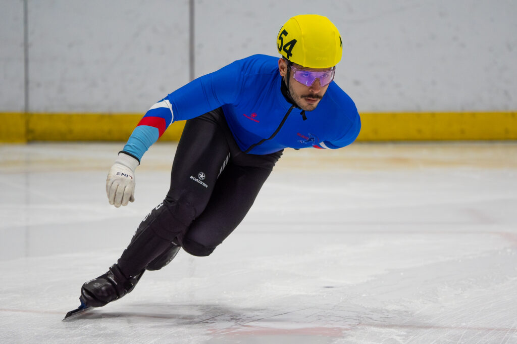 An athlete skating with helmet on the rink