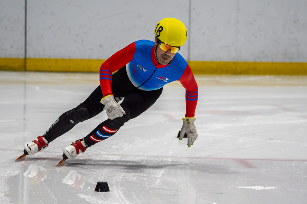 An athlete skating with helmet on the rink