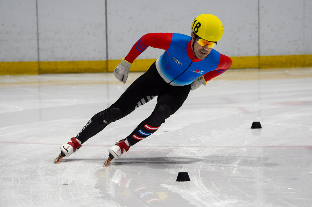 An athlete skating with helmet on the rink