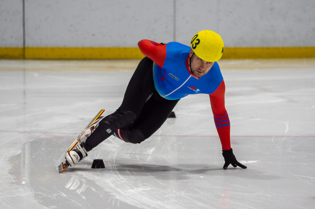 An athlete skating with helmet on the rink
