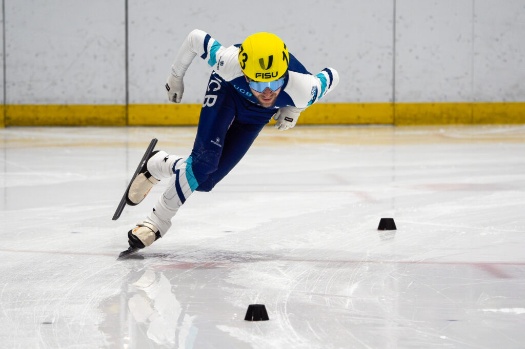 An athlete skating with helmet on the rink