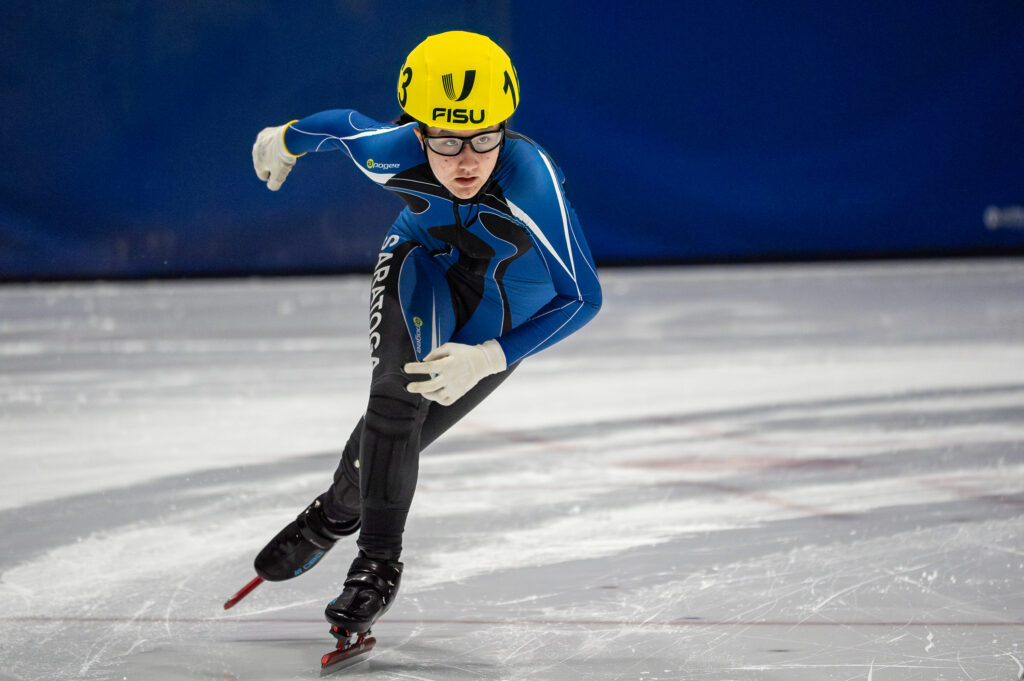 An athlete skating with helmet on the rink