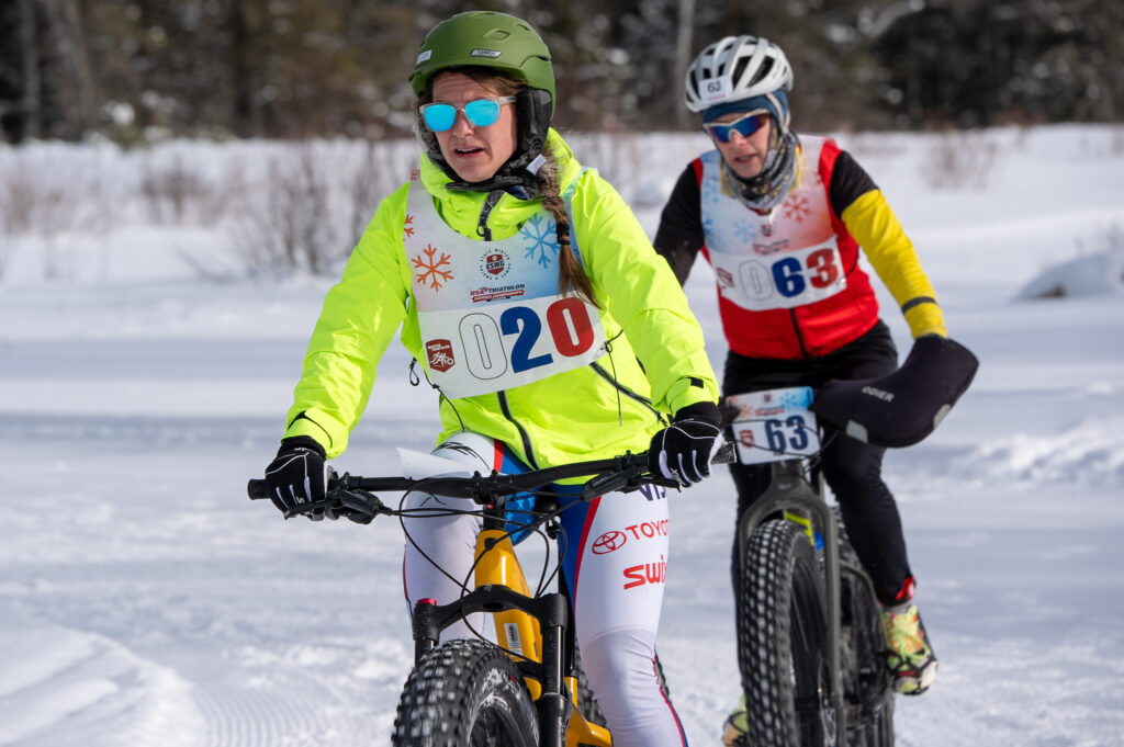 Two athletes competing in athletic event sports with helmet