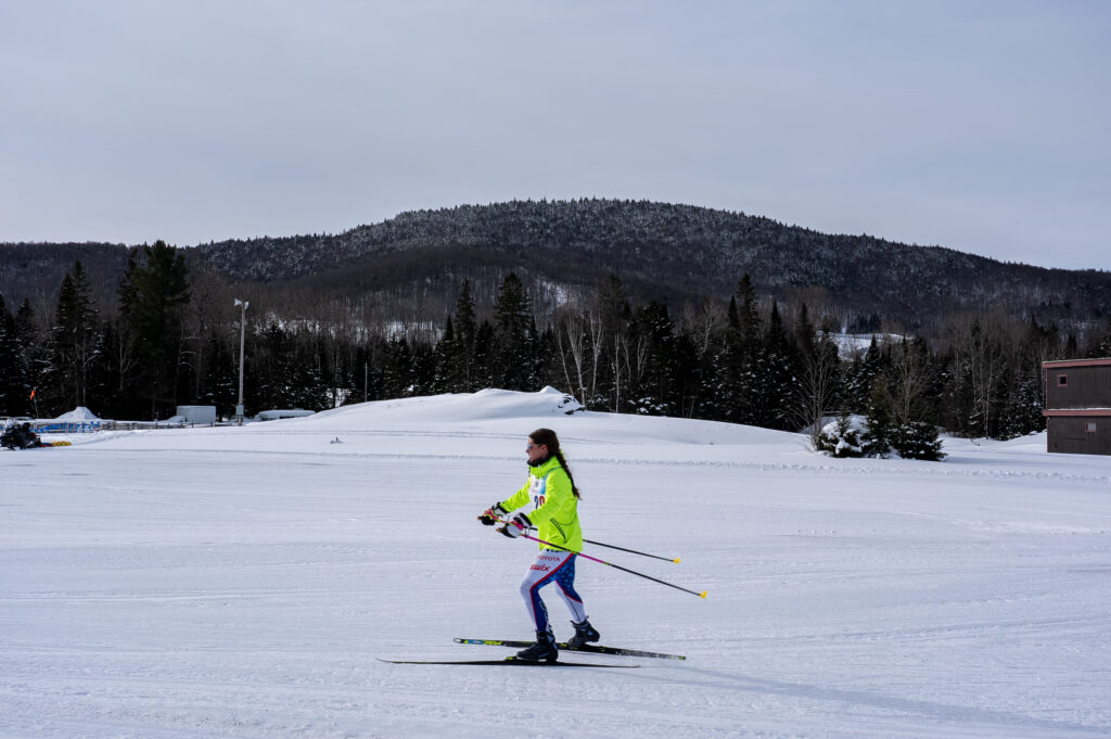 Two athletes skiing in the snow