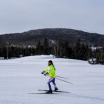 Two athletes skiing in the snow